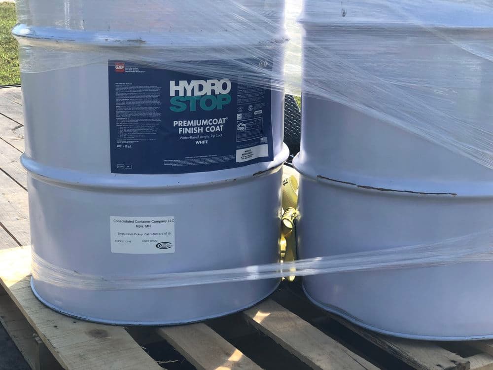 Hydro Stop Premium Coat Finish in barrels, showcasing product packaging and branding details.