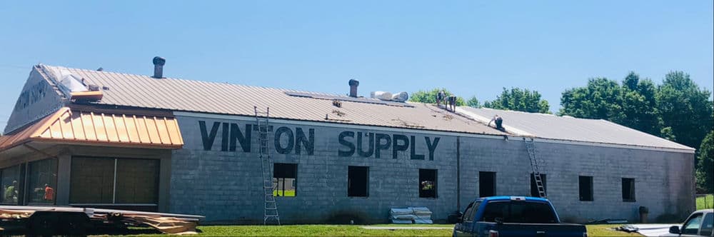Vinton Supply building with prominent signage and a blue truck outside on a sunny day.